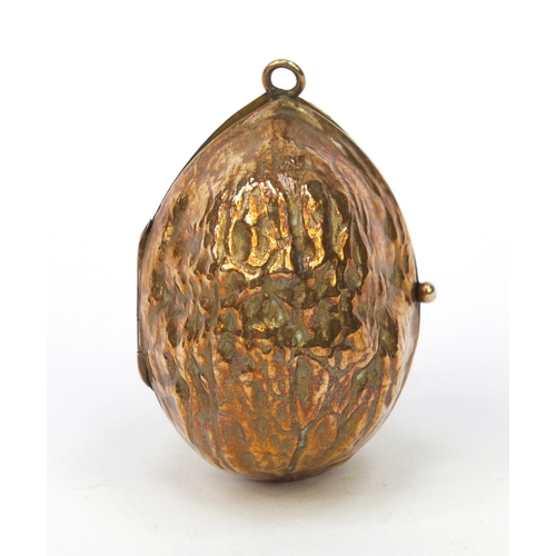 100 - Lady's pendant brass compact in the form of a nut with mirrored interior, 4cm wide