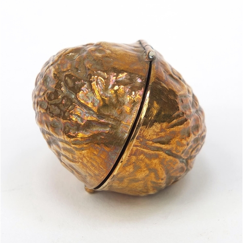 100 - Lady's pendant brass compact in the form of a nut with mirrored interior, 4cm wide