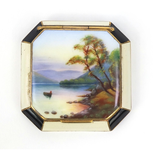 115 - Gilt metal enamelled compact, the lid enamelled with a lake and mountain, 5.5cm wide