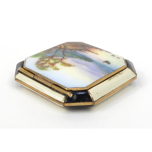 115 - Gilt metal enamelled compact, the lid enamelled with a lake and mountain, 5.5cm wide