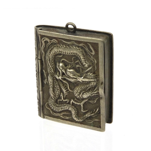 648 - Oriental Chinese silver metal book shaped pendant decorated with dragons, 2cm square