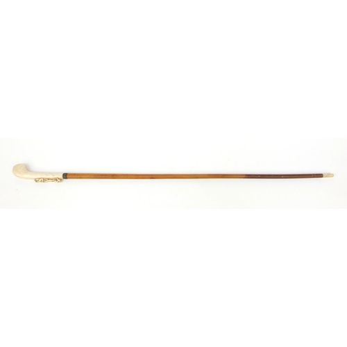 64 - Malacca walking cane with ivory handle carved as a huntsman, 82cm long