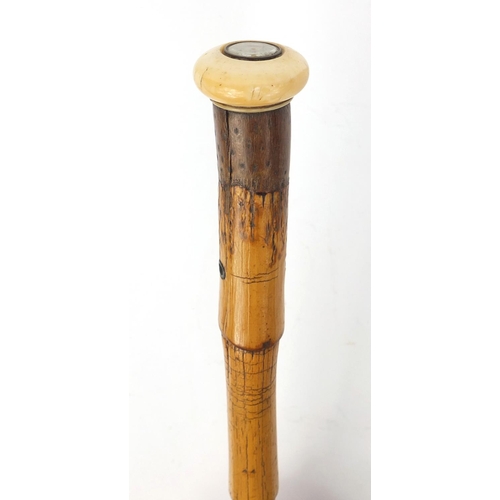 69 - Bamboo walking stick with ivory pommel inset with a compass, 95cm long