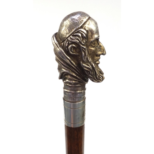 73 - Mahogany walking stick with silver topped Cardinals head, marked 'Sterling', 90cm long