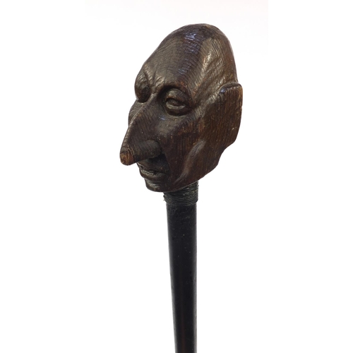 74 - Ebony walking stick with carved wooden handle modelled as a gentleman's head with a black eye, 94cm ... 