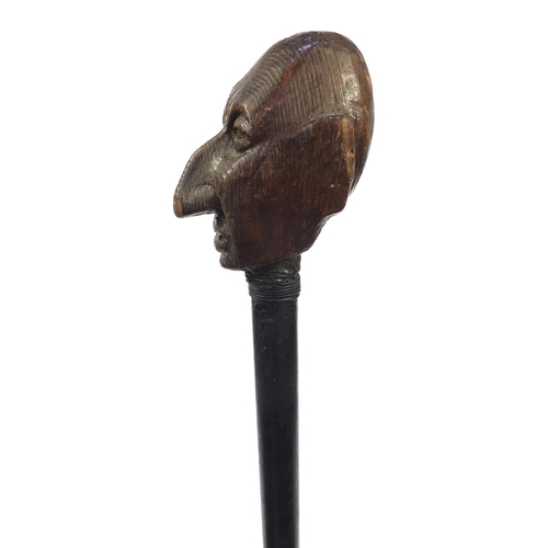 74 - Ebony walking stick with carved wooden handle modelled as a gentleman's head with a black eye, 94cm ... 