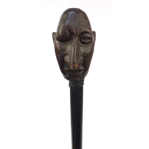 74 - Ebony walking stick with carved wooden handle modelled as a gentleman's head with a black eye, 94cm ... 