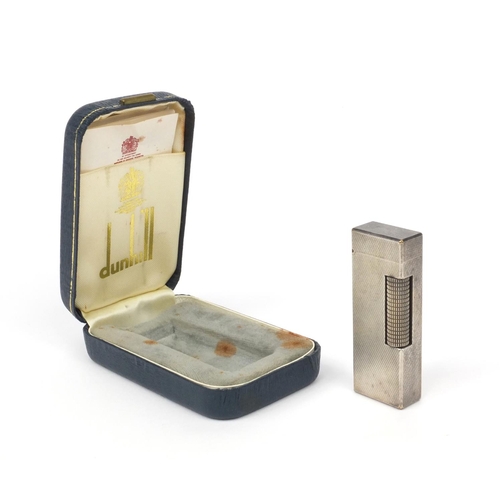 123 - Boxed silver coloured metal Dunhill lighter with engine turned decoration, 6.5cm high