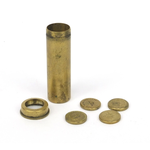 51 - Selection of intaglio moulded brass weights housed in a brass tube, the tube 5.5cm high