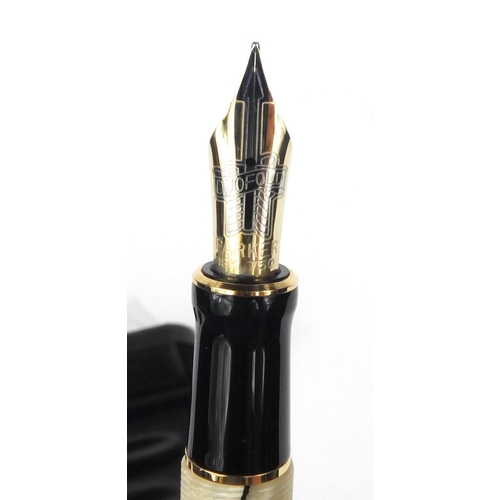 134 - Boxed Parker Duofold cream and black marbleised fountain pen with 18ct gold nib, the pen 14cm long