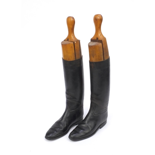 201 - Pair of black leather riding boots, both with wooden boot lasts, each 54cm high