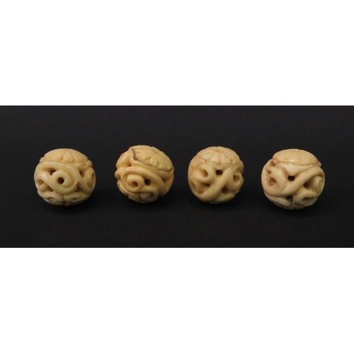 98 - Four carved ivory beads, each 2.3cm diameter