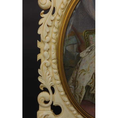 7 - Impressive European ivory easel photo frame carved with 'C' scrolls and flowers housing a hand paint... 