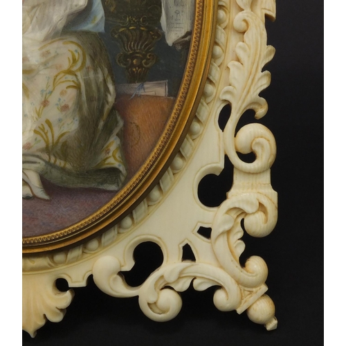 7 - Impressive European ivory easel photo frame carved with 'C' scrolls and flowers housing a hand paint... 