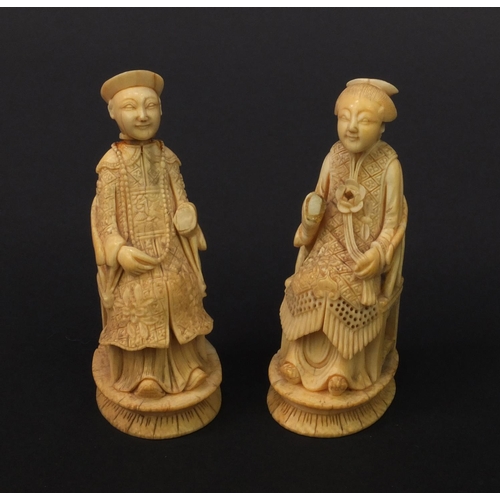 614 - Pair of oriental Chinese carved ivory figures of seated elders, the larger 8.5cm high