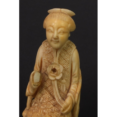 614 - Pair of oriental Chinese carved ivory figures of seated elders, the larger 8.5cm high