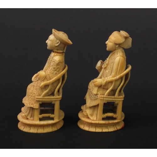 614 - Pair of oriental Chinese carved ivory figures of seated elders, the larger 8.5cm high