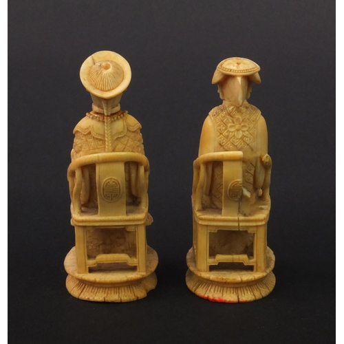 614 - Pair of oriental Chinese carved ivory figures of seated elders, the larger 8.5cm high