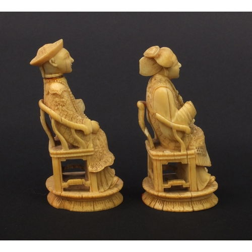 614 - Pair of oriental Chinese carved ivory figures of seated elders, the larger 8.5cm high