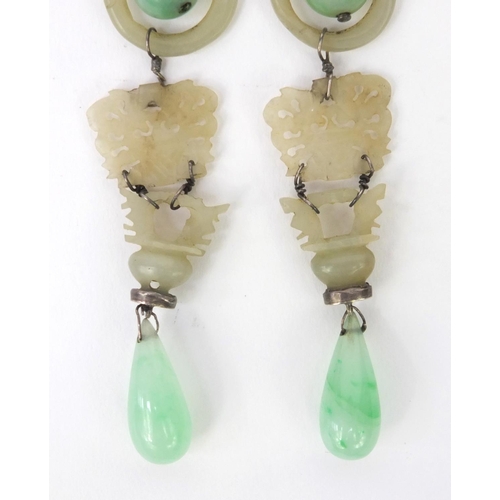 635 - Pair of oriental Chinese carved green jade drop earrings, each 9cm high