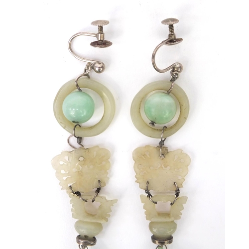 635 - Pair of oriental Chinese carved green jade drop earrings, each 9cm high