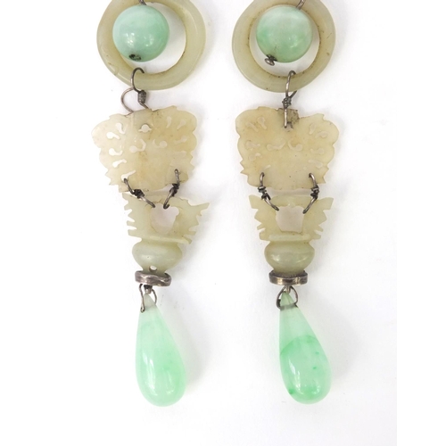 635 - Pair of oriental Chinese carved green jade drop earrings, each 9cm high