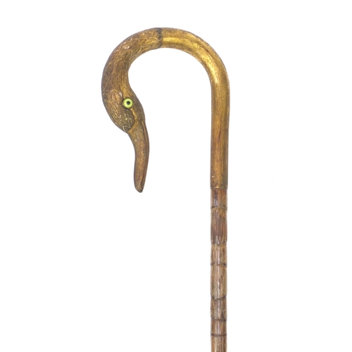 83 - Bamboo parasol with gilt brass top in the form of a swan, with beaded eyes, 91cm long