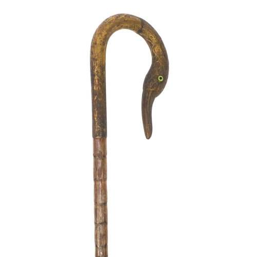 83 - Bamboo parasol with gilt brass top in the form of a swan, with beaded eyes, 91cm long