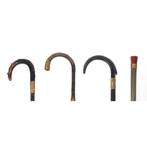 90 - Group of four walking canes including two bamboo examples, one with gold stone top, one with horn to... 