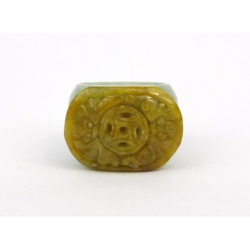 639 - Two oriental Chinese jade thumb rings - one carved with a lion, the other with bats, 3.5cm diameter