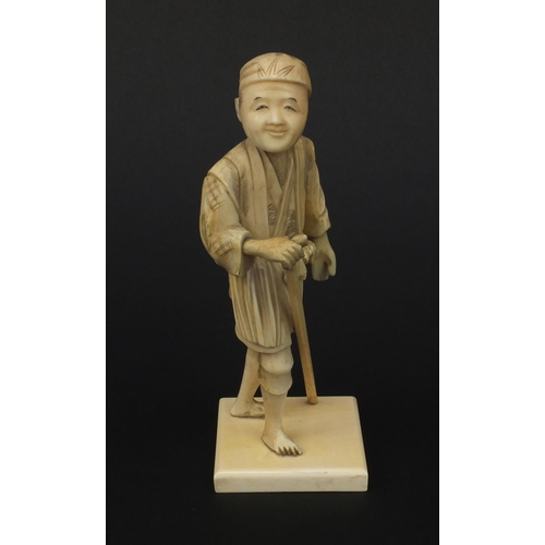 606 - Oriental Japanese ivory okimono figure of a gentleman with a stick, 15.5cm high