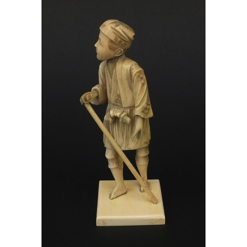 606 - Oriental Japanese ivory okimono figure of a gentleman with a stick, 15.5cm high