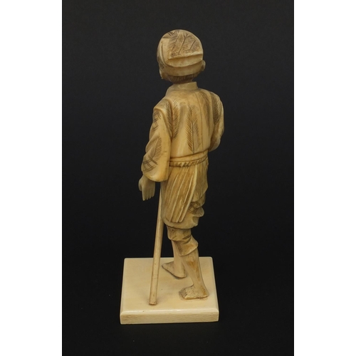 606 - Oriental Japanese ivory okimono figure of a gentleman with a stick, 15.5cm high