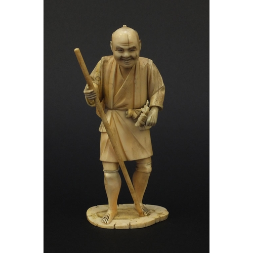 605 - Oriental Japanese ivory okimono of a gentleman with a stick and a basket, 15.5cm high