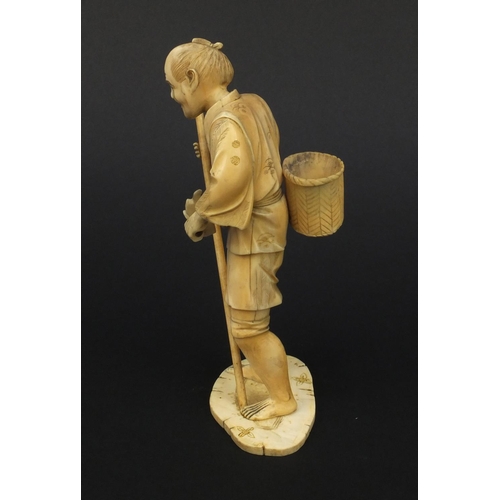 605 - Oriental Japanese ivory okimono of a gentleman with a stick and a basket, 15.5cm high