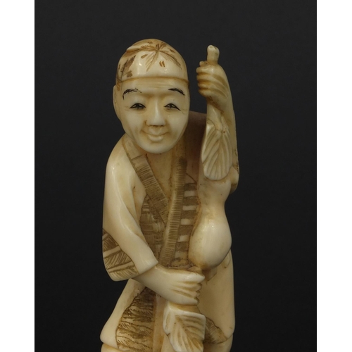 610 - Oriental Japanese ivory okimono of a gentleman with fruit, 12.5cm high