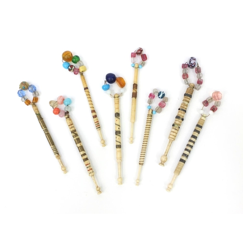 95 - Eight sewing interest antique bone lace bobbins with beaded glass tops