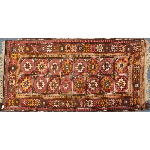 2027 - Middle Eastern rug with geometric boarder onto a predominately brown ground, the central field decor... 