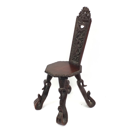 2026 - Middle Eastern hardwood octagonal chair, the back carved with a mythical beast, the legs carved as s... 
