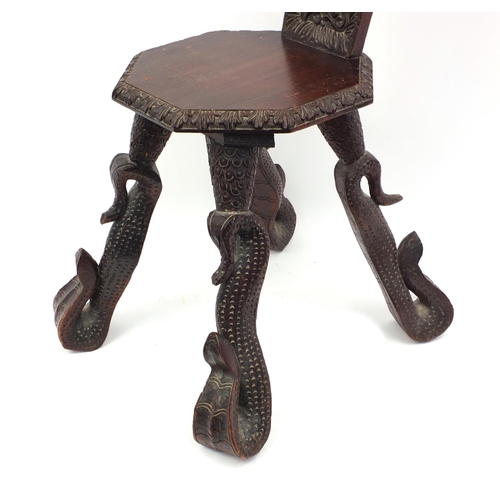 2026 - Middle Eastern hardwood octagonal chair, the back carved with a mythical beast, the legs carved as s... 