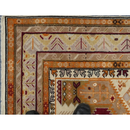 2022 - Rectangular Middle Eastern rug with geometric border, the central field decorated with geometric ser... 