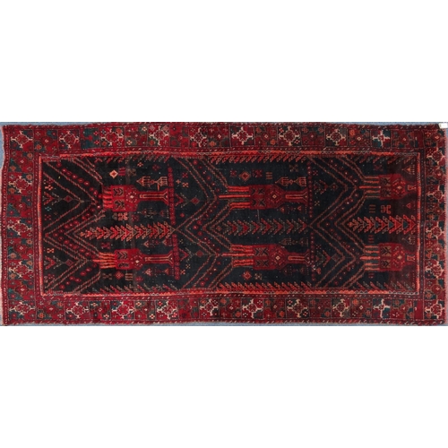 2036 - Large rectangular Middle Eastern rug with geometric border, the central field with stylised trees on... 