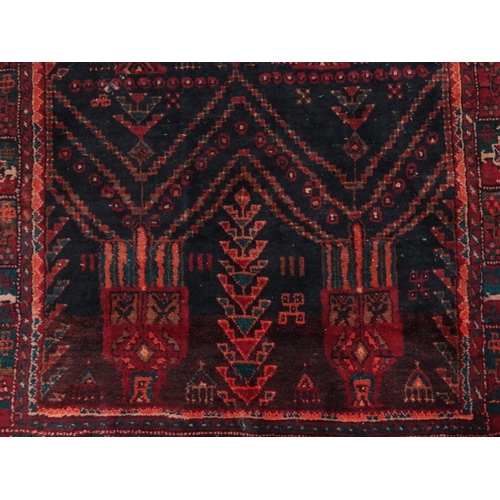 2036 - Large rectangular Middle Eastern rug with geometric border, the central field with stylised trees on... 
