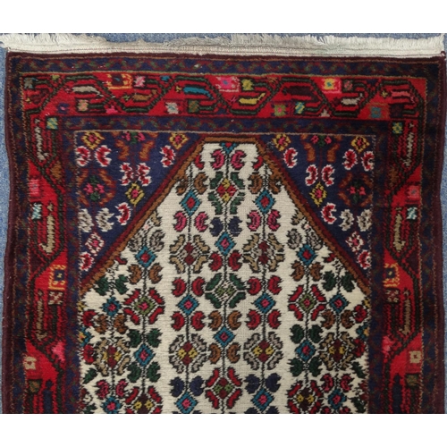 2040 - Rectangular Middle Eastern geometric patterned carpet runner, the geometric border onto a red ground... 