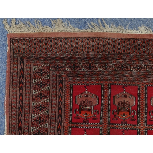 2009 - Rectangular Middle Eastern rug with geometric border, the central field decorated with a continuous ... 