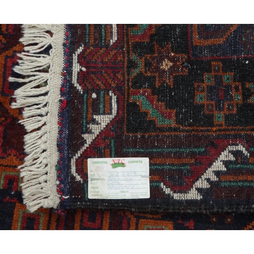 2039 - Rectangular Afghan wall rug with oriental N.F.C. Carpets label, the border and central field with ge... 