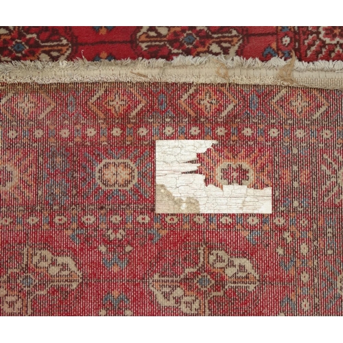 2041 - Rectangular Middle Eastern rug with geometric border and the central field with floral decoration on... 