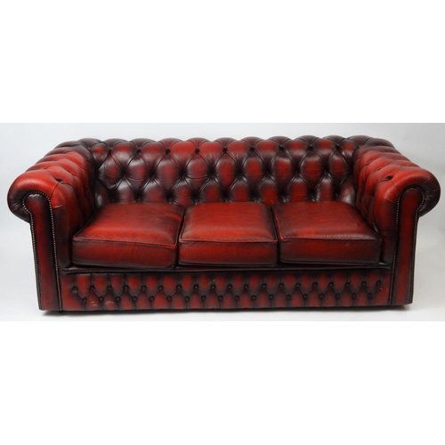 3 - Oxblood leather buttonback three seater Chesterfield settee, approximately 180cm long