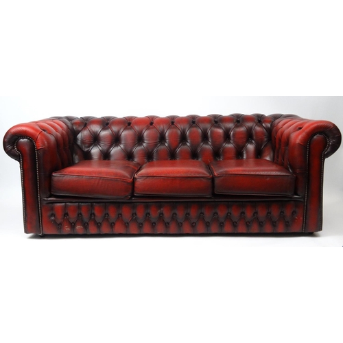 3 - Oxblood leather buttonback three seater Chesterfield settee, approximately 180cm long