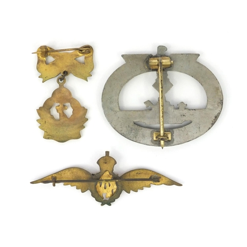 380 - Three military interest badges including a German military interest U-boat badge an enamelled RAF ba... 